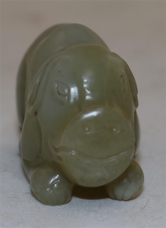 A Chinese pale celadon jade figure of a recumbent pig, 19th century, 5.6cm